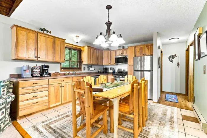 Fuel up for a day of outdoor adventure in this welcoming kitchen, outfitted with a sleek stainless steel refrigerator, coffee maker, and gas range. Gather everyone at the log dining table to plan your daily itinerary over breakfast.