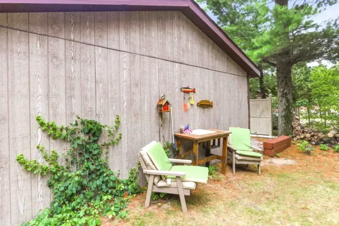 Clean your daily catch at the convenient outdoor fish cleaning station before unwinding in the cushioned outdoor patio chairs in this cozy, shaded backyard corner.