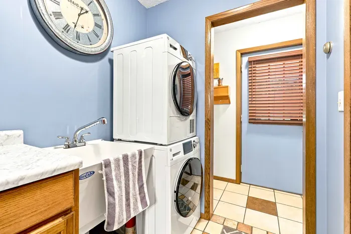 Keep vacation extended stays effortless with a dedicated laundry room equipped with a stacked washer and dryer and a deep utility sink. Perfect for washing beach towels and muddy gear after a day exploring the outdoors, ensuring a seamless, worry-free stay