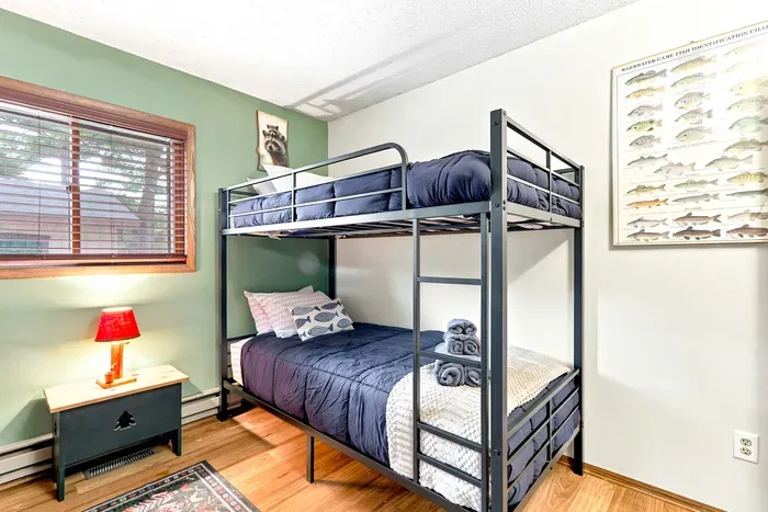 Drift off to sleep in this playful bedroom featuring two twin-over-twin bunk beds and thoughtful touches like fresh bath towels and cozy bedding. An overhead ceiling fan keeps the room breezy and cool all night long.