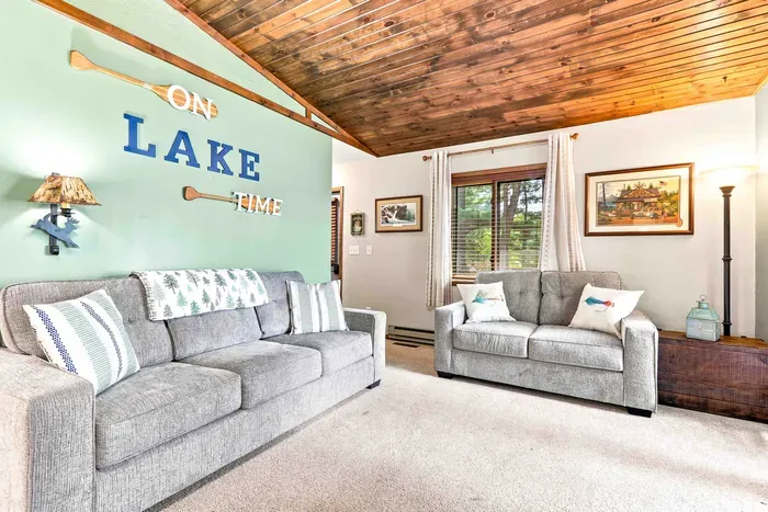 Settle into "Lake Time" in a bright, inviting living room designed for ultimate relaxation. Curl up on the plush sofa next to the stone fireplace or kick back with your favorite show on the wall-mounted flat-screen TV.