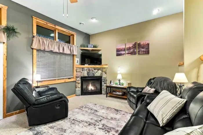 Warm and inviting, this comfortable sitting room offers a peaceful space to relax. Enjoy the warmth of the crackling stone fireplace, watch your favorite shows on the corner TV, or sink into plush leather seating with a good book.