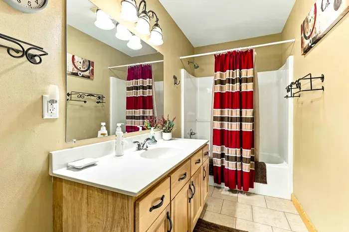 Enjoy a clean and comfortable space to refresh after a long day on the lake. Outfitted with tile flooring, a shower/tub combination, bright vanity vanity lighting, and plentiful counter space, this full bath easily accommodates your group.