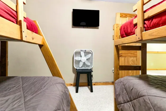 Wind down with a movie before sleep! This dedicated bunk room provides comfortable double-level sleeping arrangements arranged around a wall-mounted TV for easy viewing from any bed.