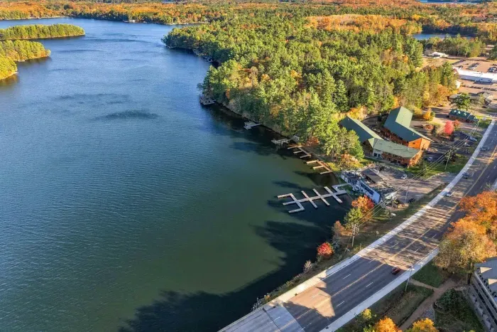 Spectacular lakefront views and private boat dock access! Enjoy prime water access framed by stunning autumn foliage.