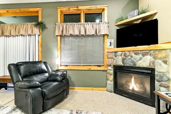 Whether you're gathering for family board game night or lounging after a day outdoors, this room has space for everyone. Soft carpet, patterned accent rugs, and rich leather seating make it a cozy haven, complete with direct outdoor access.