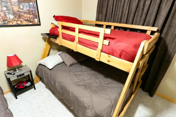 Maximize capacity without compromising comfort. Outfitted with sturdy solid-wood bunk beds, neutral decor, and ceiling fan cooling, this spacious room is built to comfortably host your whole crew.