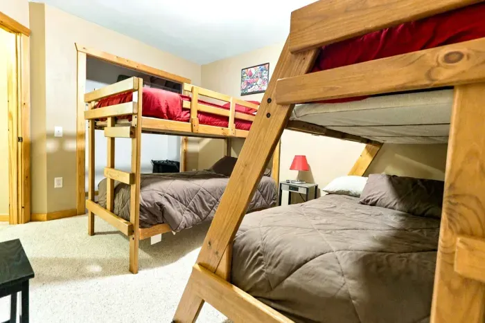 Rest up after a day of outdoor fun in this functional bunk room. Soft bedding, warm wood accents, and a overhead ceiling fan make this a quiet and relaxing space for a great night's sleep.