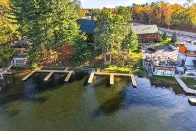 Experience the ultimate waterfront getaway nestled among vibrant fall foliage and towering pines. With expansive boat docks giving you direct access to crystal-clear waters, your days can be spent boating, swimming, or simply soaking in the lake.