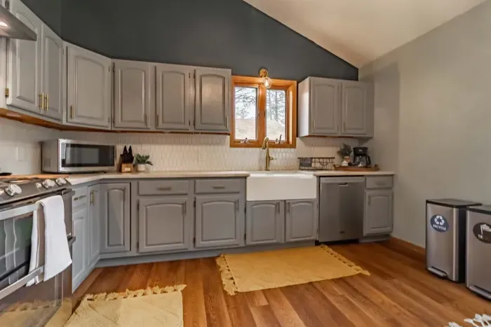 Modern and efficient—everything you need to create a delicious meal. The kitchen features a stainless steel refrigerator, stove, coffee maker, kitchenette oven, kettle, and blender