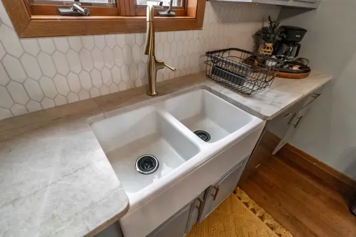 Modern and efficient—everything you need to create a delicious meal. The kitchen features a stainless steel refrigerator, stove, coffee maker, kitchenette oven, kettle, and blender