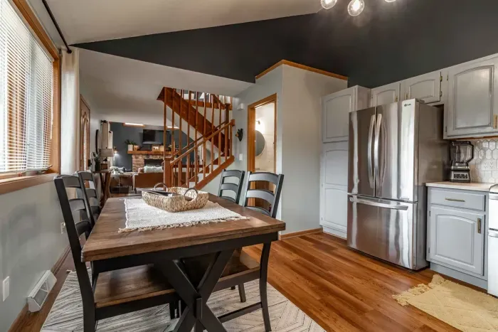 Modern and efficient—everything you need to create a delicious meal. The kitchen features a stainless steel refrigerator, stove, coffee maker, kitchenette oven, kettle, and blender