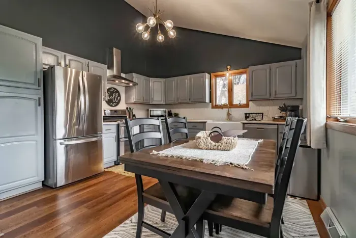 Modern and efficient—everything you need to create a delicious meal. The kitchen features a stainless steel refrigerator, stove, coffee maker, kitchenette oven, kettle, and blender