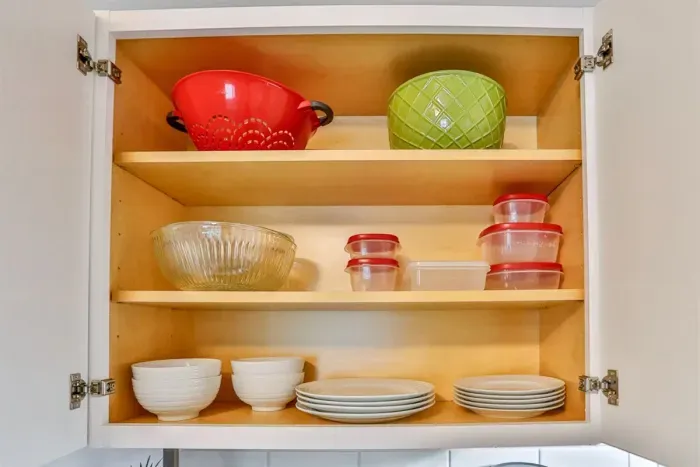 A modern kitchen equipped with high-end appliances and ample lighting. It has a coffee maker, oven, stove top, utensils, and all it takes to fix a delicious meal.