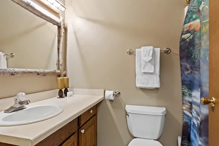 A tidy bathroom offering a vanity. Perfect for guests seeking comfort, functionality, and convenience.