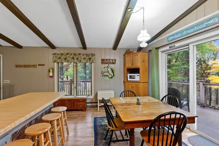 The bar seating is perfect for quick meals or evening chats over drinks. Its cottage charm and practical layout make it a welcoming spot for cooking and gathering.