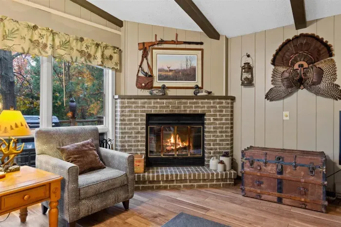 Fireplace mantel adorned with nature-inspired art and decor.