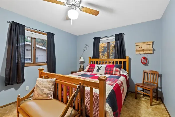 The wooden headboard and side tables create a timeless charm, while soft textiles and ambient lighting make the bedroom feel like a serene sanctuary.
