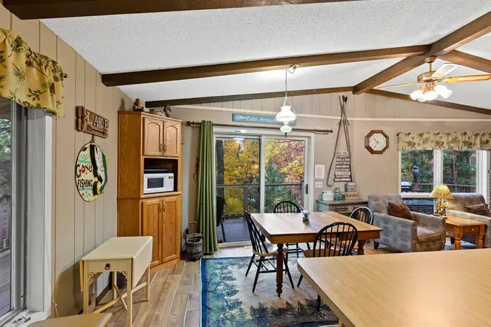 Perfect cabin retreat for families, couples, or groups seeking lake escape. Open-plan layout connecting living and dining areas.