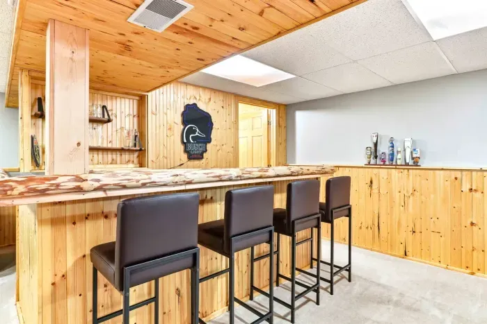 Wood-accented lounge with bar setup perfect for social gatherings.