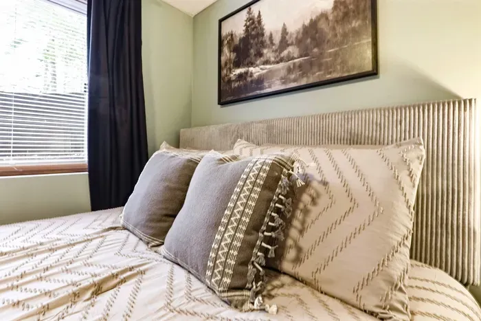 Comfortable bedroom with soft bedding and calm vibes.