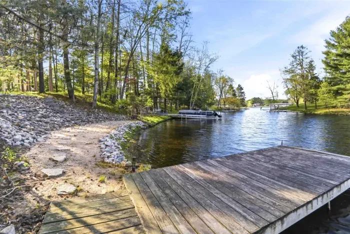 Step onto the dock, follow the sandy shoreline, and enjoy quiet days on the water in a peaceful wooded setting.