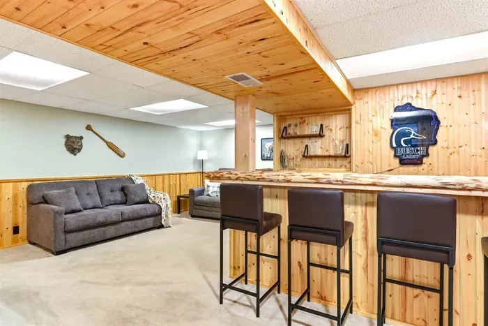 Spacious basement entertainment room with cozy, rustic charm.