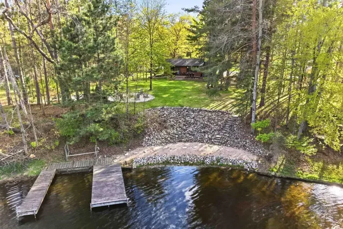 Arrive by water and unwind in your own wooded escape, complete with a private dock, natural shoreline, and a cozy cabin tucked beneath the trees. From sunny afternoons on the water to quiet evenings by the fire, this setting captures the best of lakeside l