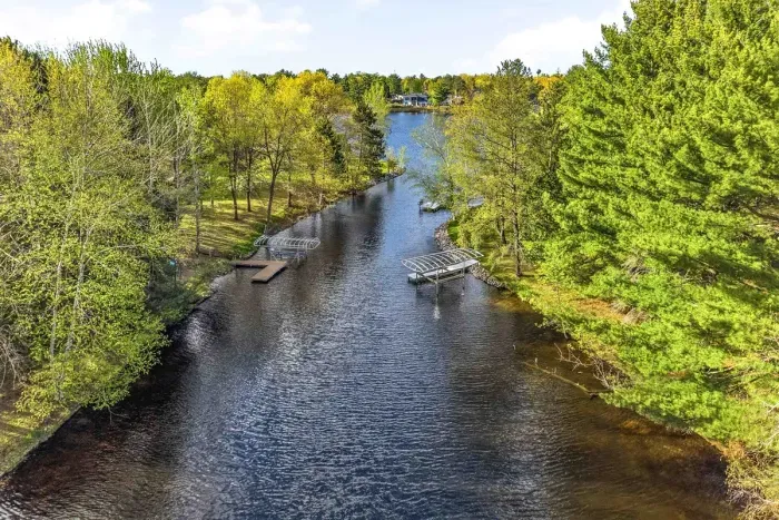 A peaceful shoreline retreat where wooded privacy, water access, and cabin charm come together beautifully.