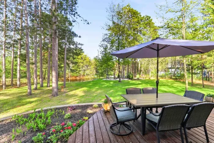 Dine outdoors with peaceful water views, towering pines, and a wide-open lawn made for slow, easy days.