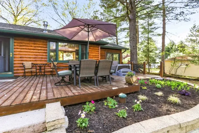 A relaxing outdoor retreat where shaded dining, lush greenery, and waterfront scenery come together beautifully.