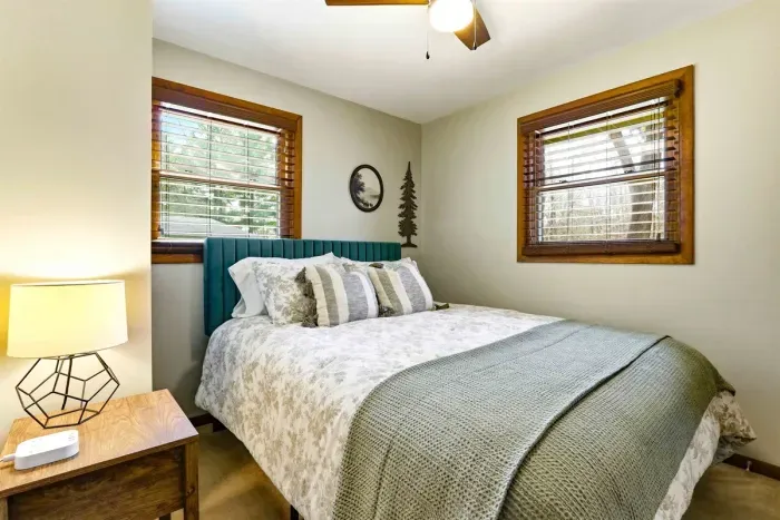 Comfortable bedroom with soft bedding and calm vibes.