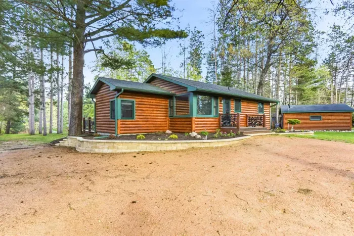 Set among mature trees and peaceful grounds, this charming cabin is made for easy lake-country living.