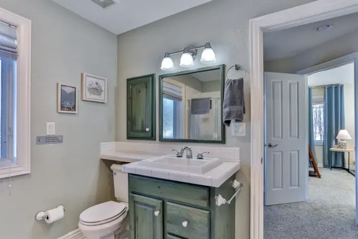 A private bathroom featuring a sink and mirror for your convenience.