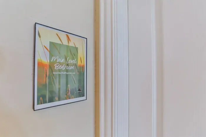 Tucked away on the main level, the bedroom is accessed through a private door, ensuring a quiet and relaxing stay.