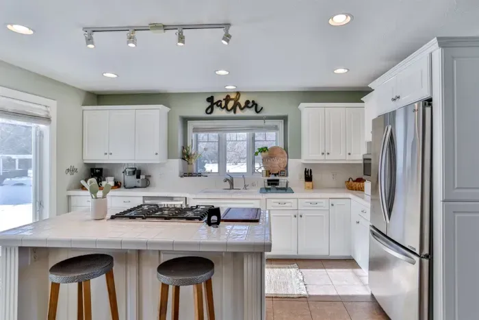 A clean, modern kitchen, fully equipped for cooking and dining. Its bright, neutral palette makes the space feel open and inviting.