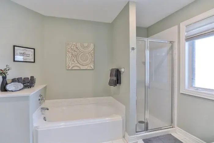 The space includes a private bathroom with a bathtub and shower, offering comfort and convenience throughout your stay.