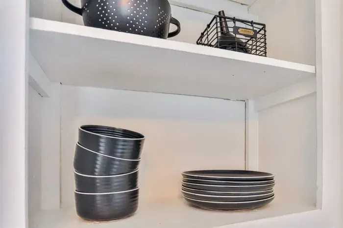 Open shelves stocked with dishes and cookware for everyday use.