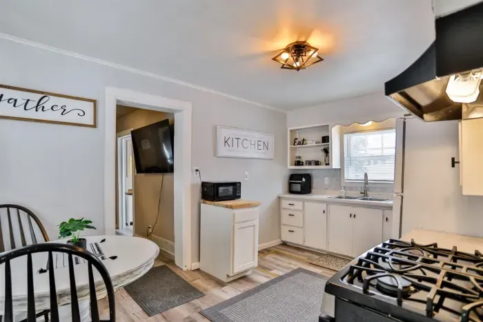 Open kitchen with full-size appliances and a small dining space for everyday meals.