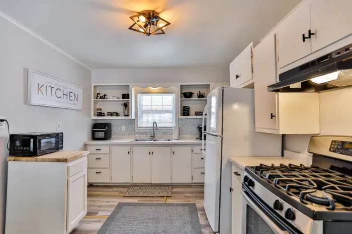 Spacious kitchen with full-size appliances, open shelving, and great natural light.