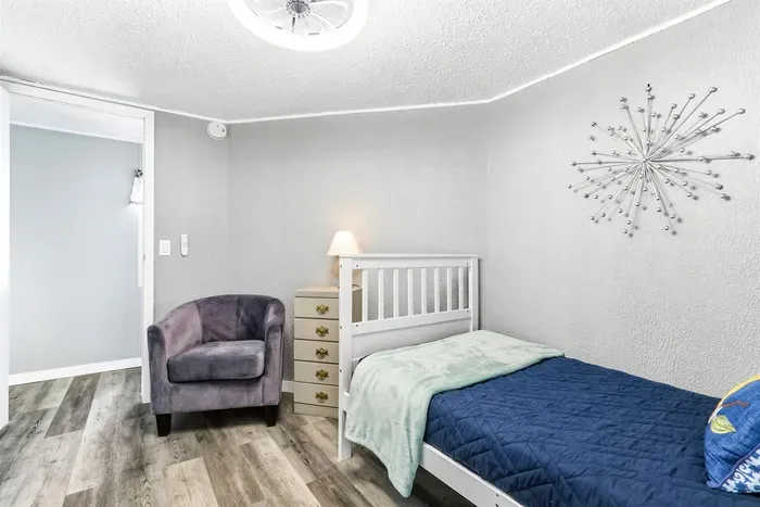 Relaxing bedroom with couch, and soft lamp glow.