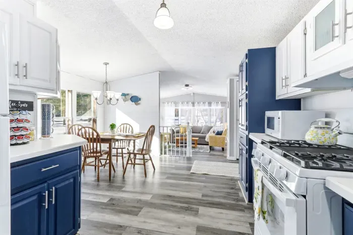 Fully equipped modern kitchen with sleek appliances and a cozy dining table, perfect for enjoying meals or entertaining guests.