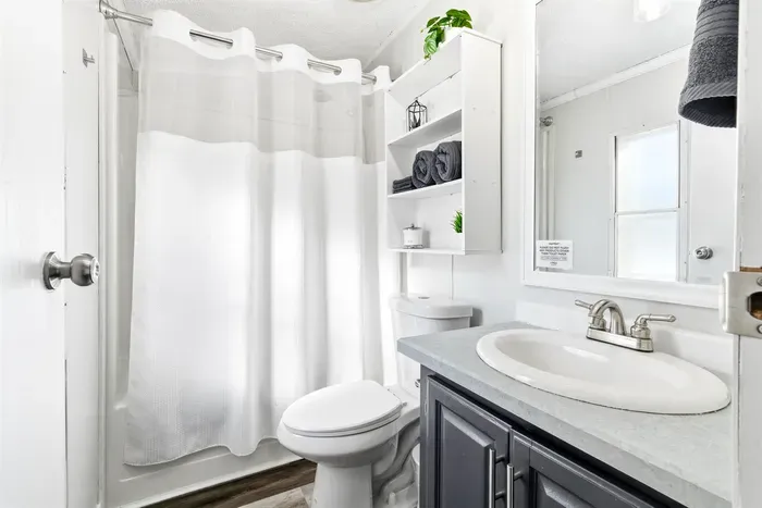 Clean, modern bathroom with all essentials, offering a bright and refreshing space to unwind.