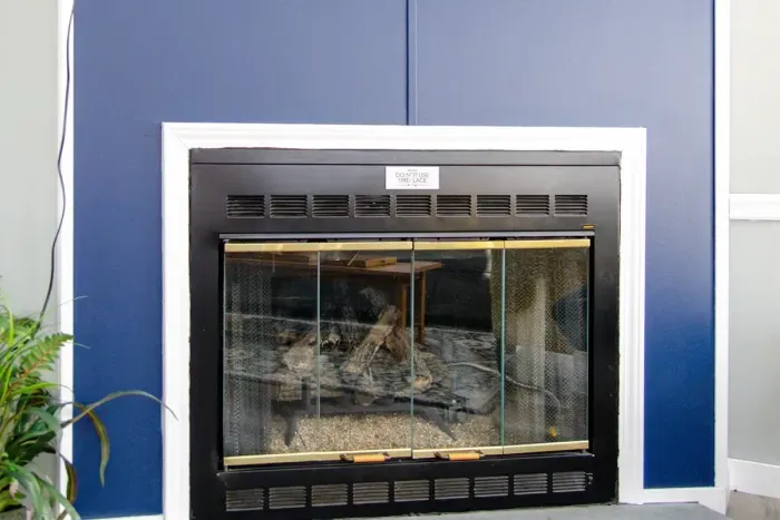 Stylish blue-accented fireplace serving as the heart of the living space.