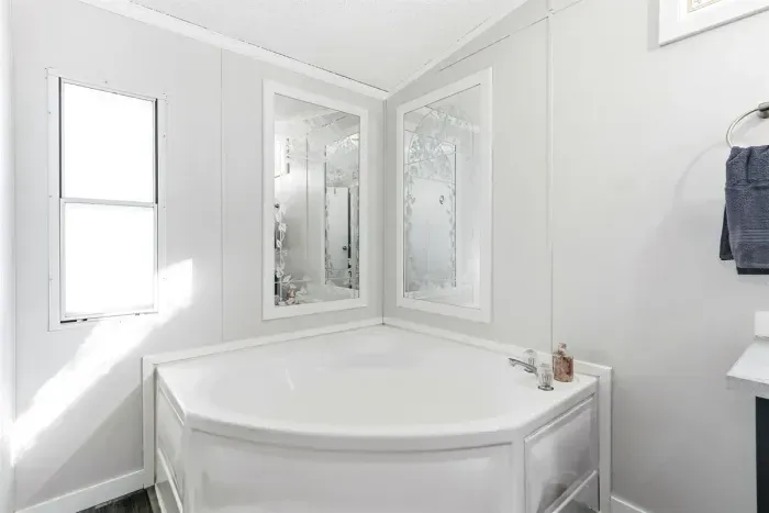 Relaxing bathroom with soaking tub and natural light.
