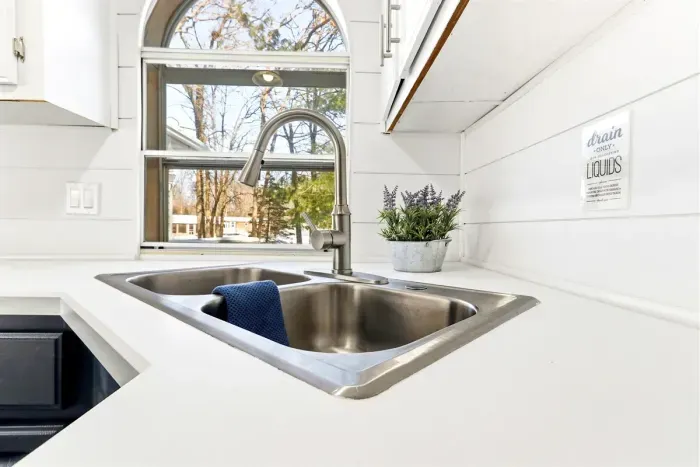 Functional kitchen with a double sink, combining style and practicality.