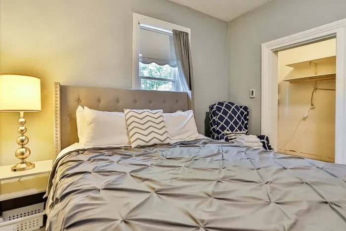 Unwind in a peaceful queen bedroom with soft lighting, fresh linens, and a quiet place to recharge.