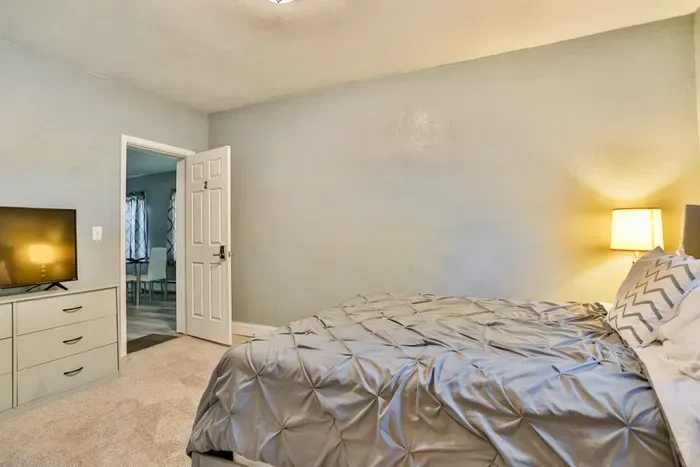 Relax in the cozy bedroom with TV, offering a comfortable space to unwind at the end of the day.