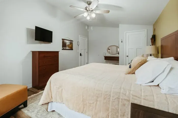 Wake up refreshed – our bedroom offers a peaceful retreat amidst the city buzz.

King sized bed
Ceiling fan
Plush bedroom interior
Stylish sofa
Smart TV