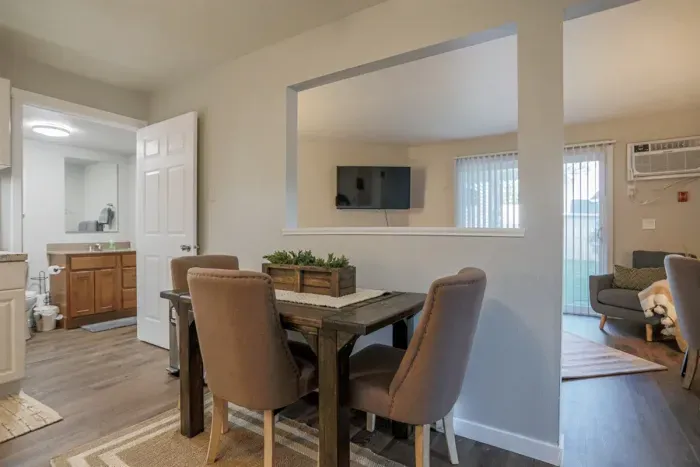 Cozy and inviting living room with comfortable seating and a modern design, perfect for relaxing after a day exploring Schofield. Enjoy high-speed Wi-Fi and streaming services on the large flat-screen TV.